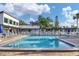 Large pool with lounge chairs and umbrellas, offering a great place to relax and enjoy the Florida sunshine at 3251 Beneva Rd # 104, Sarasota, FL 34232