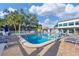 Community pool with lounge chairs and shade umbrellas, set in a relaxing outdoor environment at 3251 Beneva Rd # 104, Sarasota, FL 34232
