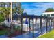 Inviting community pool area with a pergola, lounge chairs, and umbrellas for relaxation at 3251 Beneva Rd # 104, Sarasota, FL 34232