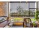 Enclosed porch featuring comfortable seating, textured walls, with relaxing outdoor views at 3251 Beneva Rd # 104, Sarasota, FL 34232