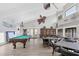 Large recreation room featuring a pool table, tables, chairs, and a library providing versatile social spaces at 3251 Beneva Rd # 104, Sarasota, FL 34232