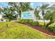 Community sign surrounded by lush landscaping, creating a welcoming entrance to Village Brooke Condominiums at 3251 Beneva Rd # 104, Sarasota, FL 34232