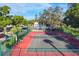 Well-maintained tennis court surrounded by mature trees and green foliage in a vibrant community setting at 3251 Beneva Rd # 104, Sarasota, FL 34232