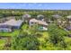 Well maintained landscaping and private pool featured in this aerial view of this custom single Gathering home at 3432 Founders Club Dr, Sarasota, FL 34240