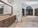 Elegant bathroom featuring a soaking tub, dual vanities, and stone floors for a spa-like experience at 3432 Founders Club Dr, Sarasota, FL 34240