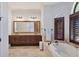 Bright and spacious bathroom with a soaking tub, dual vanities, and modern fixtures at 3432 Founders Club Dr, Sarasota, FL 34240