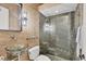 Stylish bathroom featuring a glass sink and a pebble-tiled shower with glass enclosure at 3432 Founders Club Dr, Sarasota, FL 34240