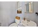 Powder room with gray walls, toilet with decorative basket, and window with shutter at 3432 Founders Club Dr, Sarasota, FL 34240