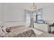 Bright bedroom with plush patterned bed, window with sheer curtains, and white dresser at 3432 Founders Club Dr, Sarasota, FL 34240