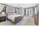 Serene bedroom with neutral tones, featuring a comfortable bed and access to an outdoor patio at 3432 Founders Club Dr, Sarasota, FL 34240