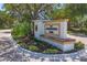 Attractive community welcome sign with lush landscaping and a natural shaded canopy at 3432 Founders Club Dr, Sarasota, FL 34240
