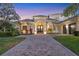 Inviting exterior of a home featuring a circular driveway, tile roof, and well-maintained landscaping at 3432 Founders Club Dr, Sarasota, FL 34240