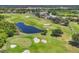 An aerial view of a lush green golf course featuring water hazards, sand traps, and manicured fairways surrounded by beautiful homes at 3432 Founders Club Dr, Sarasota, FL 34240