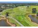 Panoramic view of a green golf course, showcasing trees, water features, sand traps, and manicured landscapes at 3432 Founders Club Dr, Sarasota, FL 34240