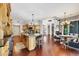 Open kitchen with granite counters, island with seating, and hardwood floors at 3432 Founders Club Dr, Sarasota, FL 34240