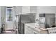 Laundry room with stainless steel washer and dryer, sink, and wood floors at 3432 Founders Club Dr, Sarasota, FL 34240