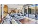 Spacious living room featuring a plush sectional sofa and hardwood floors, opening to a beautiful outdoor patio at 3432 Founders Club Dr, Sarasota, FL 34240