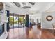 Living room with fireplace, hardwood floors, and open access to the pool at 3432 Founders Club Dr, Sarasota, FL 34240