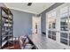 Home office showcasing custom metal table, hardwood floors, and ample shelving for storage at 3432 Founders Club Dr, Sarasota, FL 34240