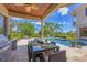 Covered outdoor dining area features a full kitchen, ceiling fan, and seating for six with a view of the pool at 3432 Founders Club Dr, Sarasota, FL 34240