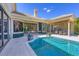 Beautiful outdoor space with swimming pool, patio, and built-in outdoor kitchen at 3432 Founders Club Dr, Sarasota, FL 34240
