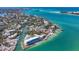 Panoramic aerial view showcasing a waterfront community with coastal homes, canals, and pristine sandy beaches at 3465 Gulfmead Dr, Sarasota, FL 34242