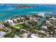 Stunning aerial view of an island community with beautiful waterfront homes, lush greenery, and tranquil canals at 3465 Gulfmead Dr, Sarasota, FL 34242