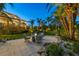 Outdoor space with a fire pit area, seating, and beautifully landscaped greenery at 3465 Gulfmead Dr, Sarasota, FL 34242