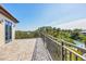 This luxury balcony offers stunning views of lush greenery and a tranquil waterfront setting at 3465 Gulfmead Dr, Sarasota, FL 34242