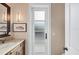 Well-lit bathroom featuring a marble countertop vanity and stylish lighting fixtures at 3465 Gulfmead Dr, Sarasota, FL 34242