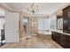 Luxurious bathroom features a chandelier, tub, and and dark wood vanities at 3465 Gulfmead Dr, Sarasota, FL 34242