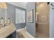 Modern bathroom featuring a glass-enclosed shower and marble-topped vanity at 3465 Gulfmead Dr, Sarasota, FL 34242