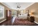 This bedroom features a four poster bed, dark wood floors, and large area rug at 3465 Gulfmead Dr, Sarasota, FL 34242