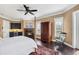 Spacious bedroom boasts wet bar, fireplace, and dark wood floors at 3465 Gulfmead Dr, Sarasota, FL 34242