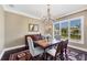 Dining room featuring a large window, chandelier, and traditional furnishings at 3465 Gulfmead Dr, Sarasota, FL 34242