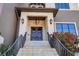 Elegant front entrance with stone steps, a covered porch, and double wooden doors at 3465 Gulfmead Dr, Sarasota, FL 34242