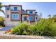 Elegant multi-story home with neutral exterior, landscaped garden, and a fountain in the front yard at 3465 Gulfmead Dr, Sarasota, FL 34242