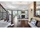 Open foyer featuring hardwood floors, staircase, and view into the home's living spaces and fireplace at 3465 Gulfmead Dr, Sarasota, FL 34242