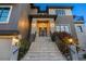 Inviting front entrance with stone steps, wrought iron railings, and elegant lighting fixtures at 3465 Gulfmead Dr, Sarasota, FL 34242