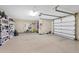 Spacious garage with epoxy floor, ample storage, and a door leading outside at 3465 Gulfmead Dr, Sarasota, FL 34242