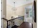 Upstairs hallway featuring hardwood floors, decorative lighting and staircase at 3465 Gulfmead Dr, Sarasota, FL 34242