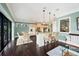 Open concept kitchen featuring an island with bar seating, stainless appliances, and dark hardwood flooring at 3465 Gulfmead Dr, Sarasota, FL 34242