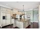 Bright kitchen features a large island with granite countertop, stainless appliances and custom cabinetry at 3465 Gulfmead Dr, Sarasota, FL 34242