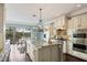 Spacious gourmet kitchen with island, stainless appliances, and an adjacent dining area with lovely backyard view at 3465 Gulfmead Dr, Sarasota, FL 34242