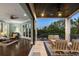 Bright living room and covered patio with comfortable seating overlooking lush greenery at 3465 Gulfmead Dr, Sarasota, FL 34242