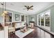 Living room with a built-in bar, large windows, hardwood flooring, and comfortable seating arrangement at 3465 Gulfmead Dr, Sarasota, FL 34242
