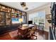 Home office featuring built-in bookshelves, a large desk, and natural light at 3465 Gulfmead Dr, Sarasota, FL 34242