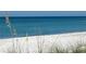Tranquil view of the beach with white sand and blue water creates a serene and inviting atmosphere at 3710 Gulf Of Mexico Dr # A20, Longboat Key, FL 34228