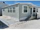 Charming single-story home featuring light green siding, white trim, and a welcoming front porch at 3710 Gulf Of Mexico Dr # A20, Longboat Key, FL 34228