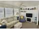 Cozy living room with comfortable seating, shelving, and a decorative fireplace at 3710 Gulf Of Mexico Dr # A20, Longboat Key, FL 34228